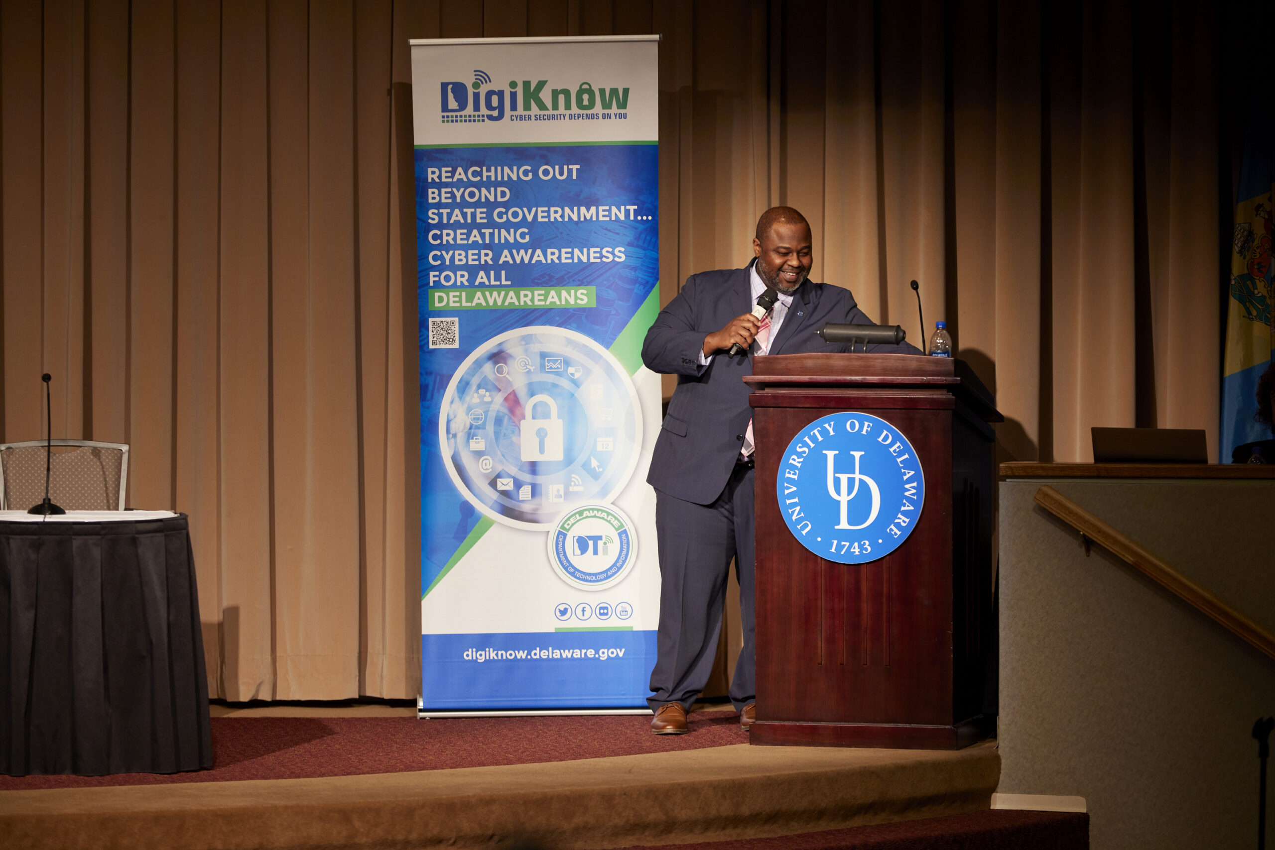 Solomon Adote Standing at a speaker's podium